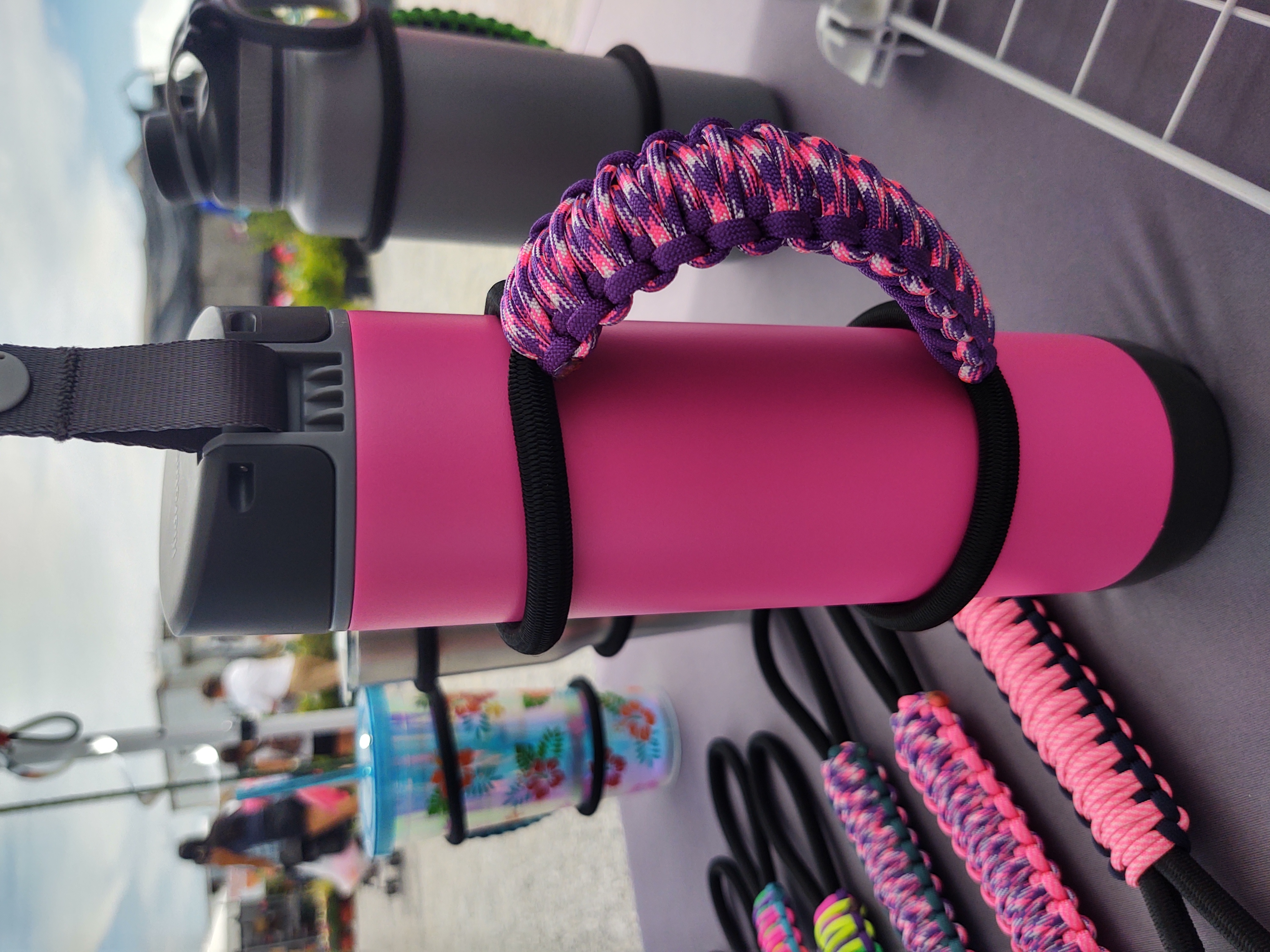 MugGripz handles and travel mugs displayed at an outdoor market