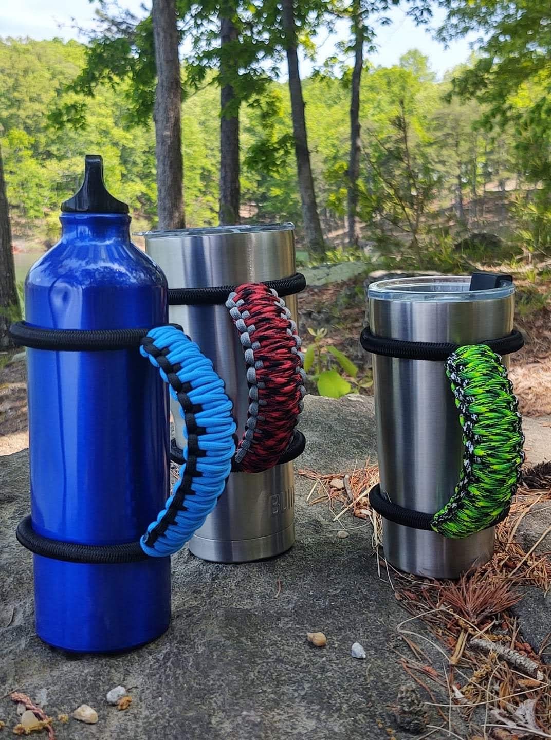 MugGripz handles fitted to travel mugs outdoors among the trees